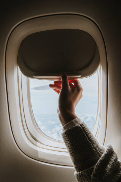istock Woman opening a window shade 2158512632