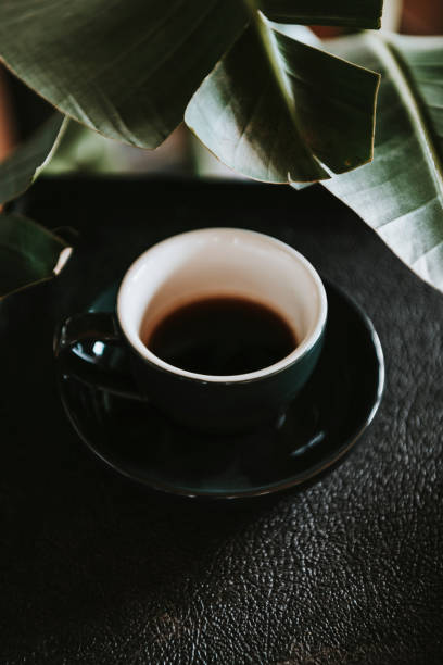 istock Coffee in a black cup in a cafe 2158513274