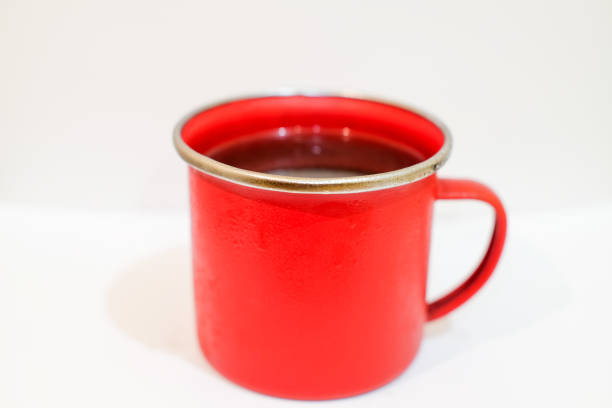 Red take-away coffee cup on the cafe table.