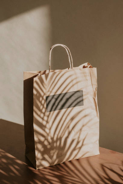 istock Natural paper bag with palm leaves shadow 2158517439