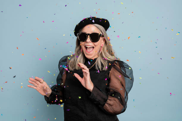 istock Cool grandma celebrating with confetti 2158517444