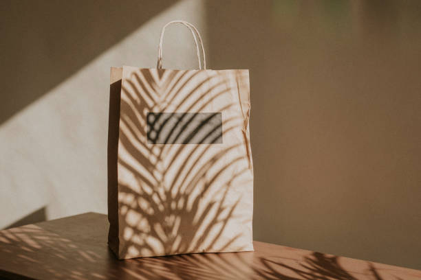 istock Natural paper bag with palm leaves shadow 2158517459