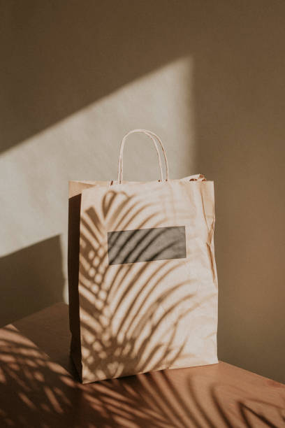 istock Natural paper bag with palm leaves shadow 2158517463