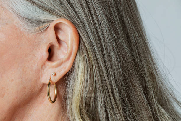 istock Senior woman with pierced ears in a profile shot 2158518072