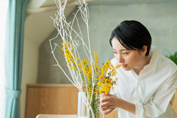 istock Women watering houseplants before work. 2158518131