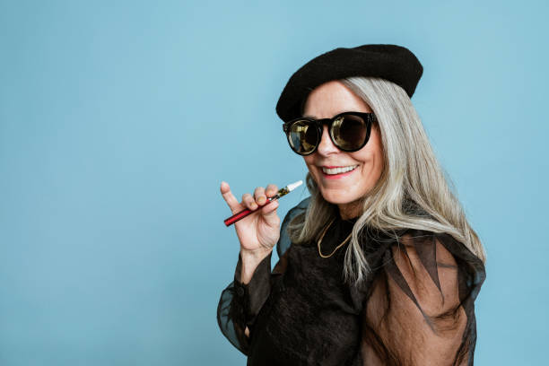 istock Cool grandma with a vape on blue background 2158518356