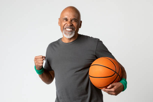 istock Happy senior man holding a basketball 2158518377