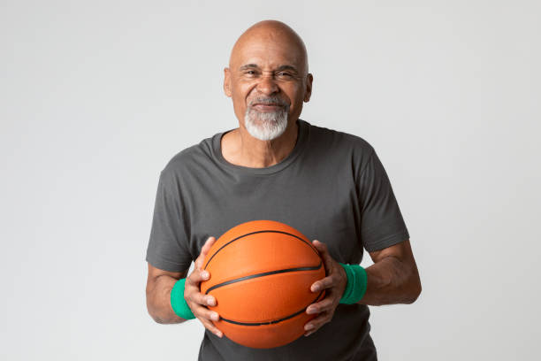 istock Happy senior man holding a basketba 2158518402