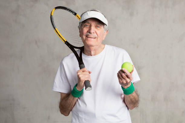 istock Cheerful senior tennis player wearing a visor cap 2158518408