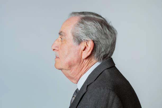 istock Senior businessman wearing a suit in a profile view 2158518451
