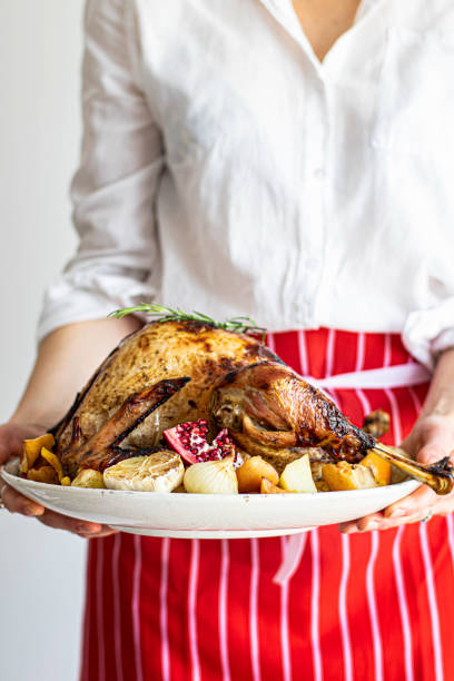 istock Woman preparing for roasted turkey for thanksgiving 2158519246