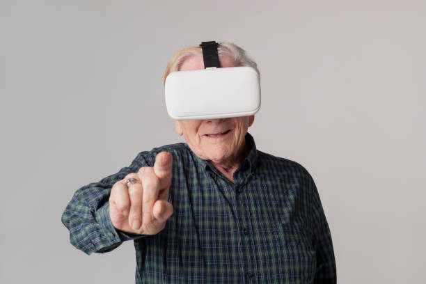 istock Cheerful senior man wearing virtual reality goggles 2158519281