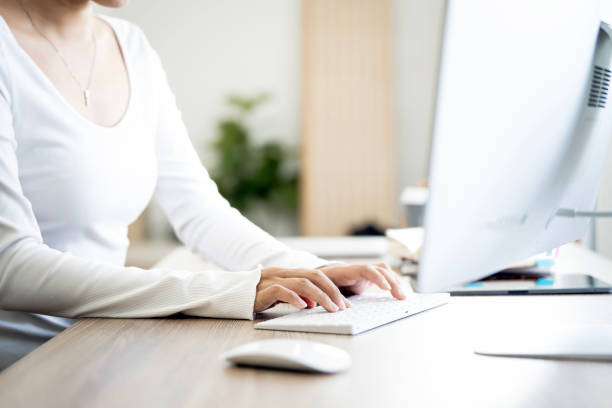 istock Close-up of woman hands typing on keyboard desktop computer 2158520600
