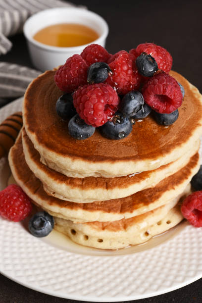 istock Homemade pancakes with berries on a dark background 2158521550