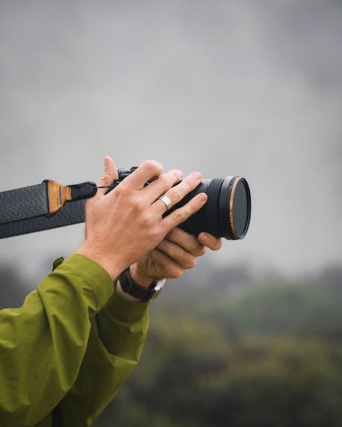 istock Man taking photos in a misty forest 2158522548