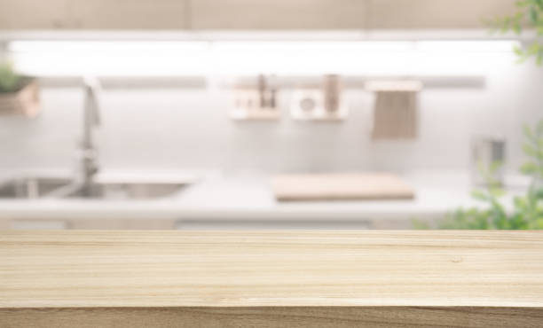 istock Wood table top counter  island  on blur cozy kitchen 2158525276
