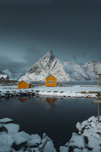 istock Yellow cabins by a snow lakeside 2158526531