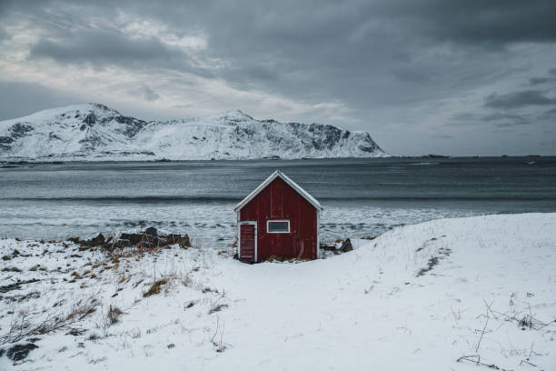 Red cabin on a snowy shore