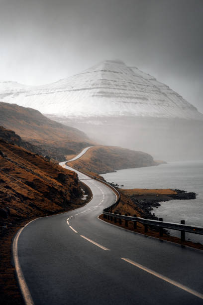 istock Scenic freeway by the lake on Faroe Islands 2158526659