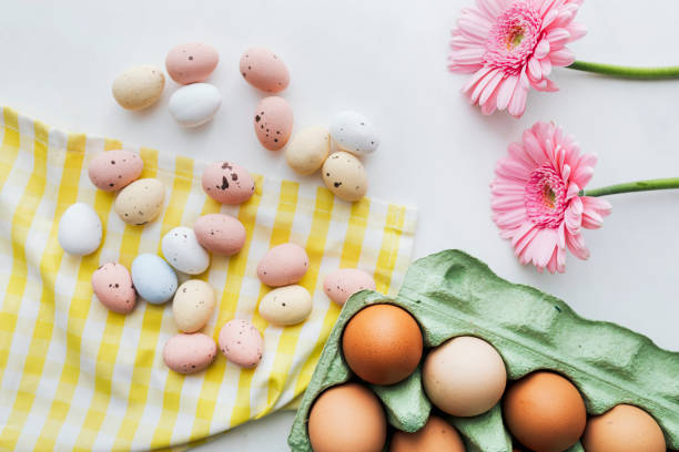 istock Chocolate Easter eggs and pink gerbera flowers flatlay 2158528836