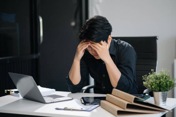 istock Businessman who is tired and overthinking from working with tablet and laptop 2158529342