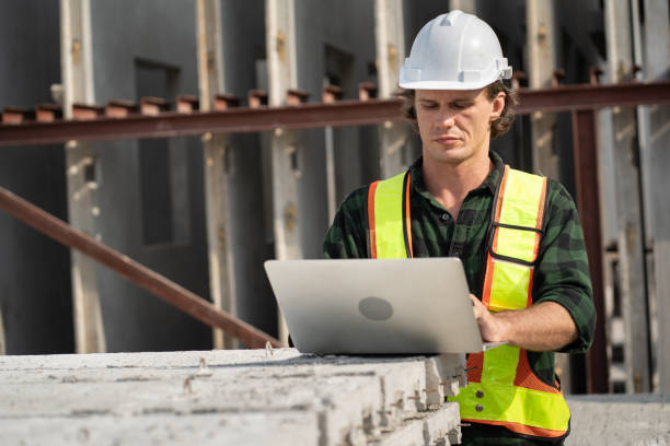 istock Portrait happy caucasian engineer man use notebook computer working at precast cement outdoor factory 2158532096
