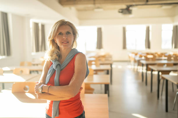 istock Portrait of smiling teacher in empty classroom 2158532255