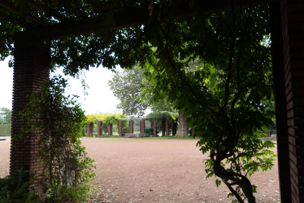 A beautiful park scenery with red brick pavillion and trees. Natural autumn scenery of Nordpark in Dusseldorf, Germany.