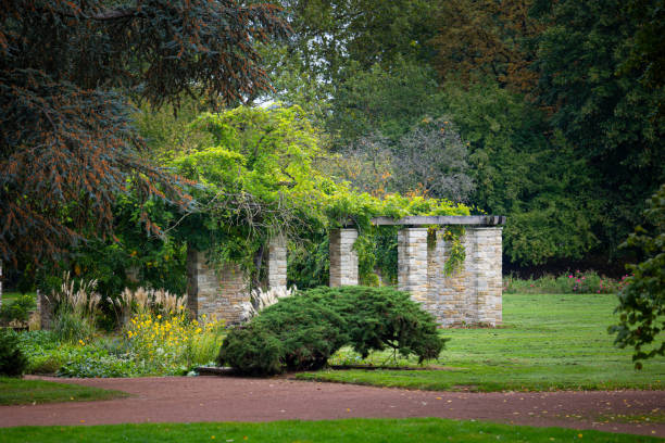 istock A beautiful park landscape with a stone brick pavillion and blooming plants. 2158533422
