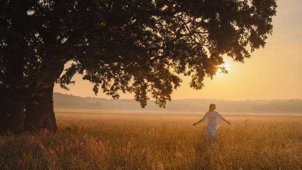 istock Serene Woman in Sunset Meadow 2158534520