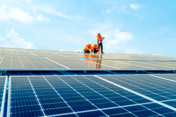 istock Male workers repair Floating solar panels on water lake. Engineers construct on site Floating solar panels at sun light. clean energy for future living. Industrial Renewable energy of green power. 2158534639