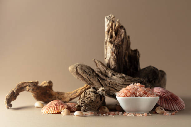 istock Pink himalayan salt with snags and seashells on a beige background. 2158535550