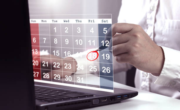istock Businessman schedules a meeting with red circle reminder on virtual calendar screen. 2158535918