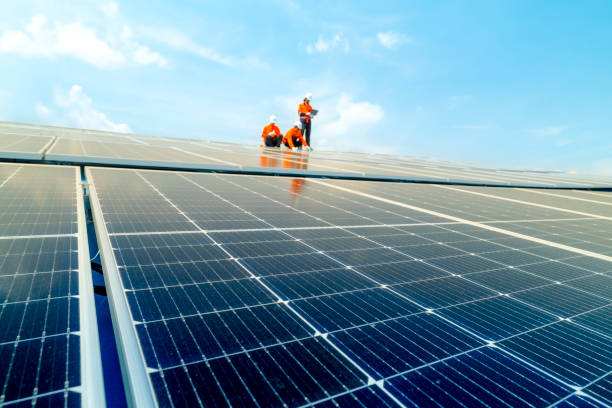 istock Male workers repair Floating solar panels on water lake. Engineers construct on site Floating solar panels at sun light. clean energy for future living. Industrial Renewable energy of green power. 2158536174