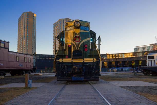 Old train collection at Toronto Railway Museum in Roundhouse Park in Toronto with city skyline in background. Toronto, Canada