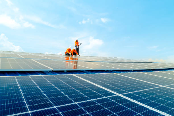 istock Male workers repair Floating solar panels on water lake. Engineers construct on site Floating solar panels at sun light. clean energy for future living. Industrial Renewable energy of green power. 2158536653