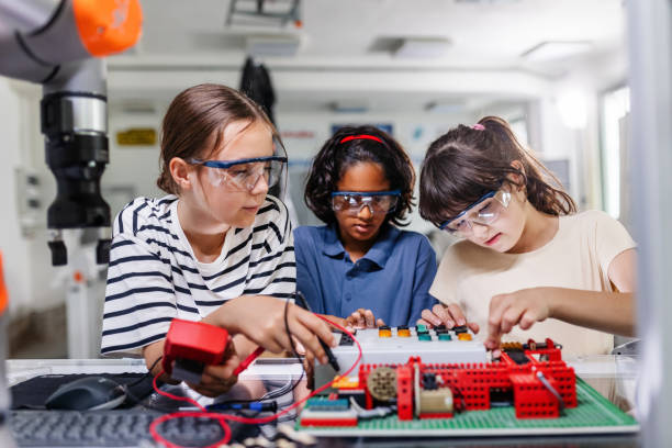 istock Classmates working togeter on circuit board, building robot in after-school robotics club. Children learning robotics in Elementary school. 2158536706