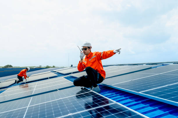 istock Male workers repair Floating solar panels on water lake. Engineers construct on site Floating solar panels at sun light. clean energy for future living. Industrial Renewable energy of green power. 2158536761