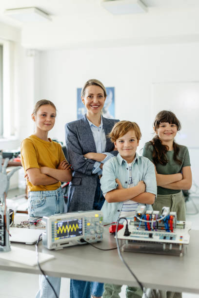 istock Children learning robotics in Elementary school. Young students building robot in after school robotics club. Field trip to real robotics laboratory. 2158536807