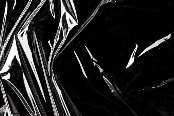 istock Wrinkled plastic wrap texture on a black background wallpaper 2158537197