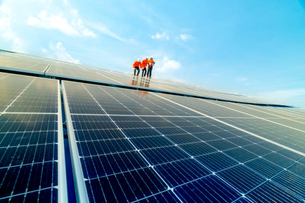istock engineer man inspects construction of solar cell panel or photovoltaic cell by electronic device. Industrial Renewable energy of green power. factory worker working on tower roof. 2158537547