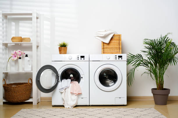 istock Modern Laundry Room With White Washing Machines and Open Door 2158537838