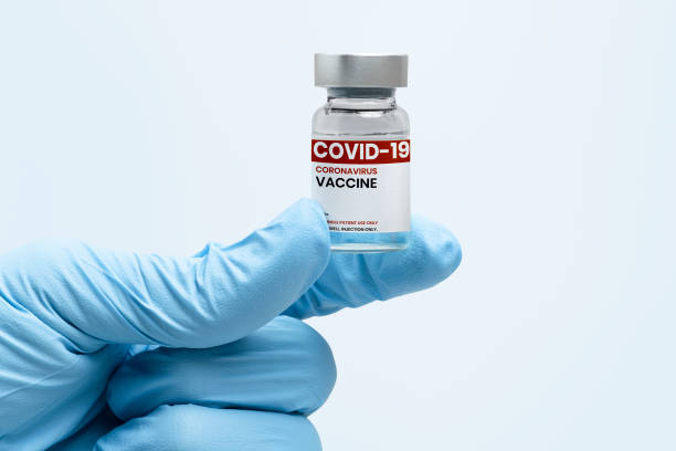 istock COVID-19 vaccine bottle in scientist's hand 2158537956