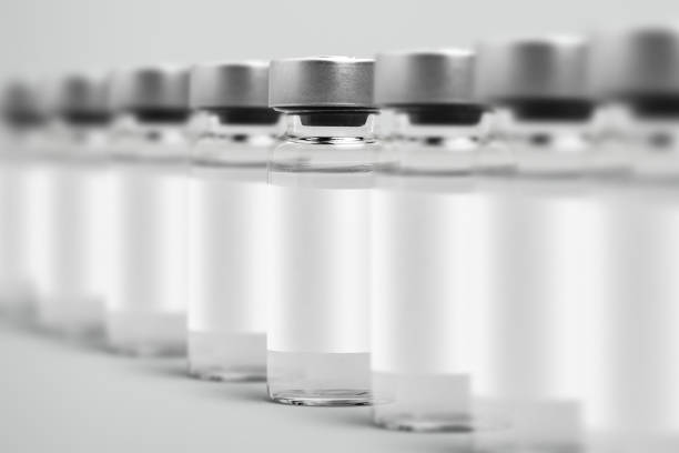 istock Vaccine injection bottles with white label in a row 2158537974