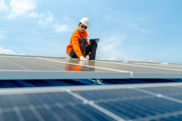 istock engineer man inspects construction of solar cell panel or photovoltaic cell by electronic device. Industrial Renewable energy of green power. factory worker working on tower roof. 2158538012