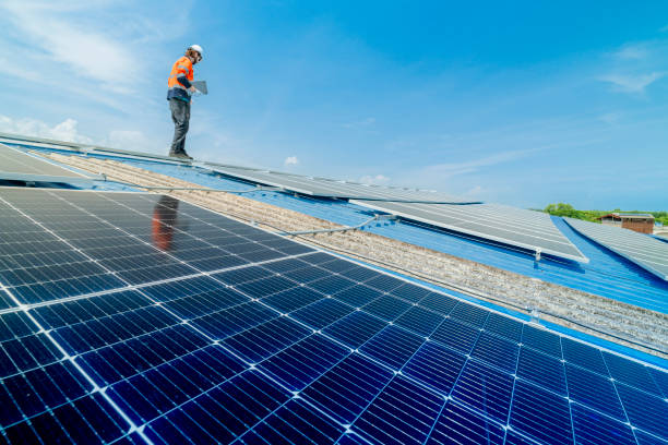 istock engineer man inspects construction of solar cell panel or photovoltaic cell by electronic device. Industrial Renewable energy of green power. factory worker working on tower roof. 2158538227