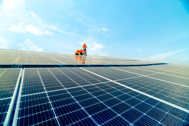 istock engineer man inspects construction of solar cell panel or photovoltaic cell by electronic device. Industrial Renewable energy of green power. factory worker working on tower roof. 2158538370