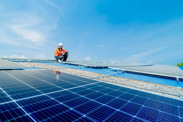 istock engineer man inspects construction of solar cell panel or photovoltaic cell by electronic device. Industrial Renewable energy of green power. factory worker working on tower roof. 2158538400