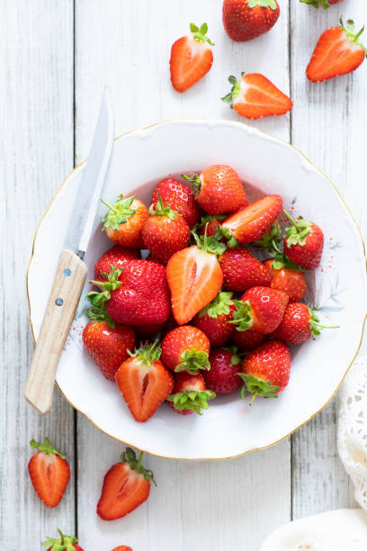 istock Strawberry plate with knife top view 2158538590