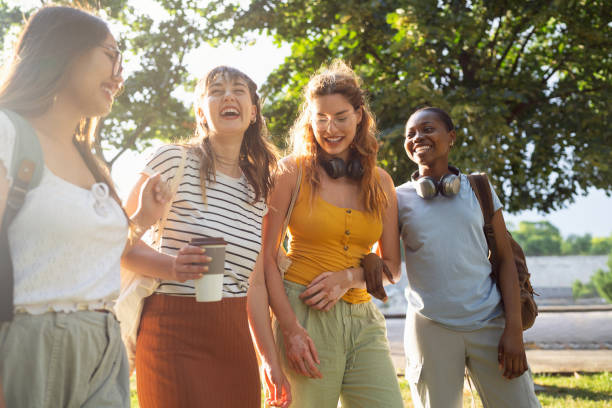 istock Group of multiracial female University students walking through the campus park 2158539103